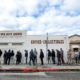 Photo of people lining up outside of a gun store