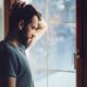 Photo of a man staring out the window