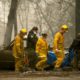 Photo of firefighters and deputies carrying a body of a Camp Fire victim