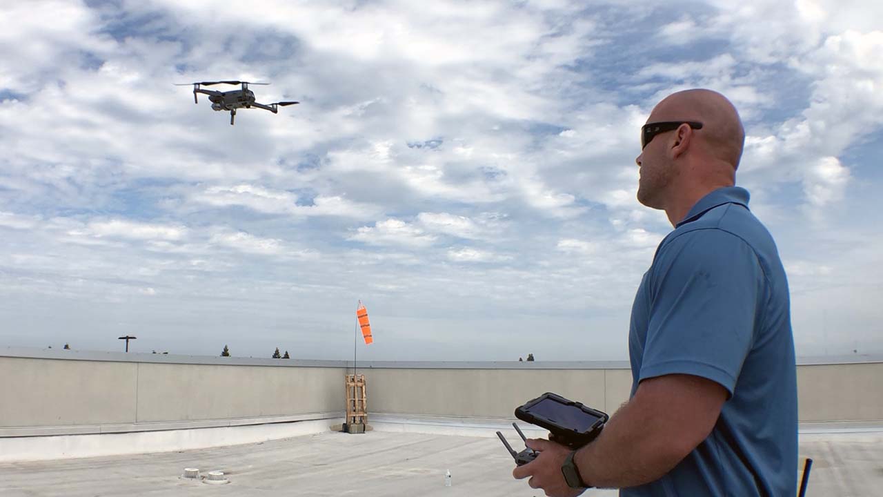 Photo of a drone and its operator