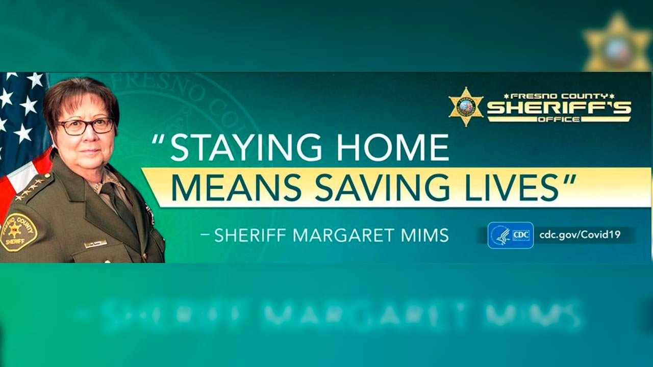 Photo of COVID-19 billboard featuring Fresno County Sheriff Margaret Mims