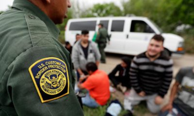 Photo of a border patrol agent talk to a group of people