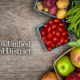 Composite image of Fresno Unified School District logo and assorted fresh fruits and vegetables