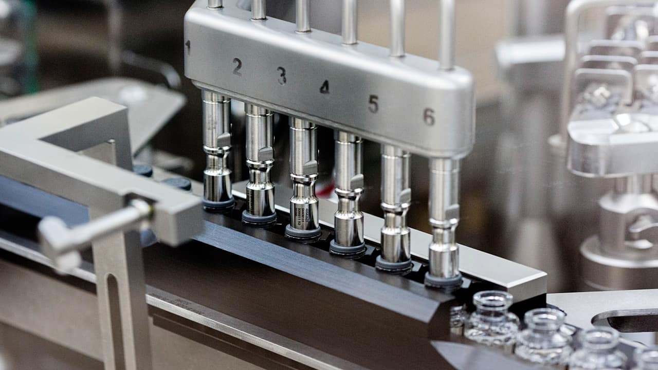 Photo of rubber stoppers placed onto vials