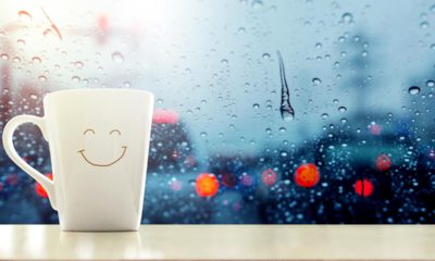 Photo of a happy face mug with rain droplets in the background