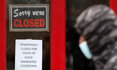 Photo of a man walking past a closed store