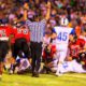 Photo of a referee signaling a touchdown in a high school football game