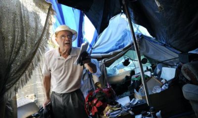 Photo of George Hostetter interviewing a homeless person