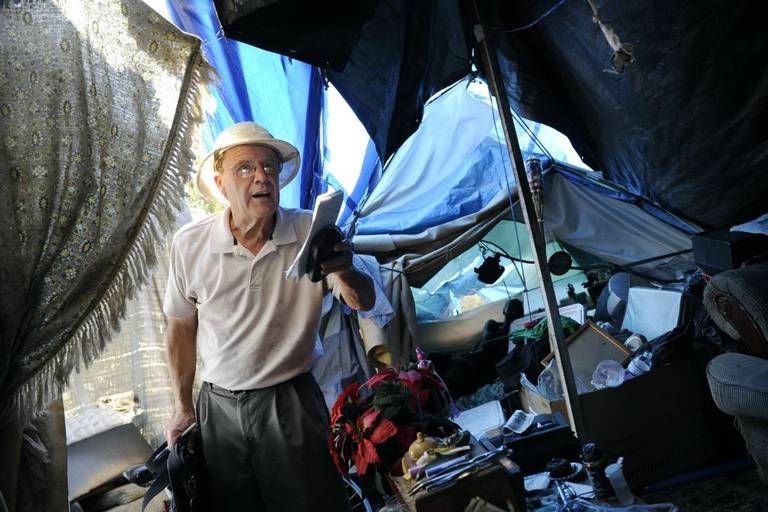 Photo of George Hostetter interviewing a homeless person