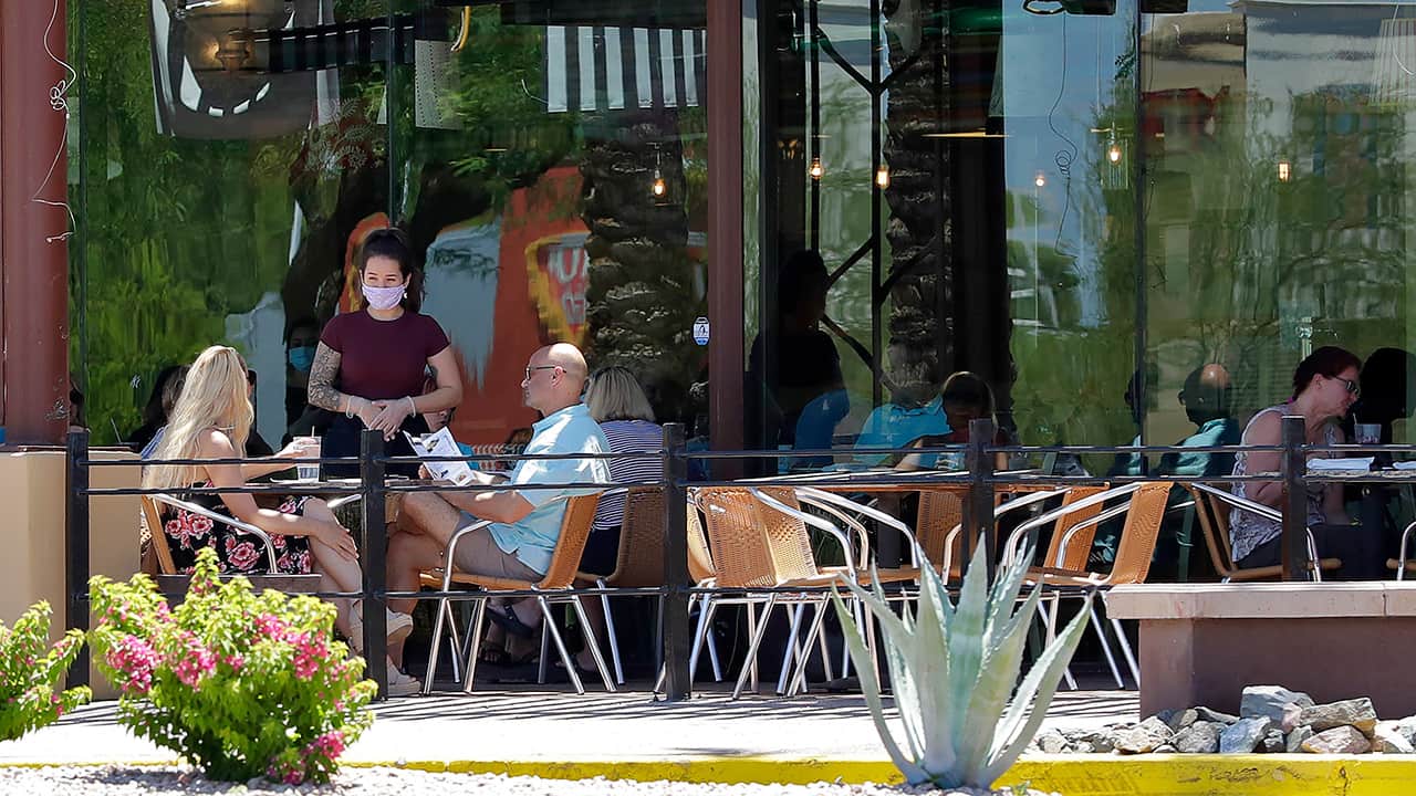 Photo of restaurant guests and mask wearing server in Phoenix, Arizona faguest