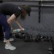 Photo of a woman cleaning weights