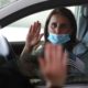 Photo of a woman during a drive-thru naturalization service