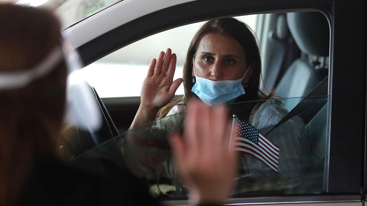 Photo of a woman during a drive-thru naturalization service