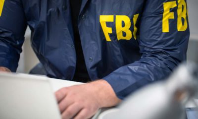 Image of an FBI agent working on a laptop