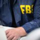 Image of an FBI agent working on a laptop
