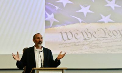 Photo of Andrew Fiala with an image of the U.S. Constitution in the background
