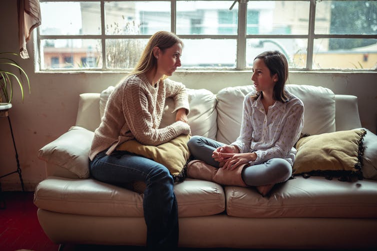 Image of a mother and child talking on a couch