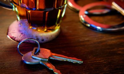 Image representing drunken driving: a beer glass, car keys, and handcuffs