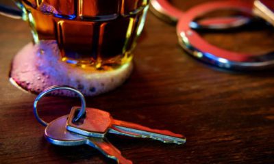 Image of a beer glass, handcuffs and car keys signifying drunken driving arrest