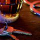 Image of a beer glass, handcuffs and car keys signifying drunken driving arrest