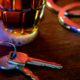 Image representing drunken driving: a beer glass, car keys, and handcuffs