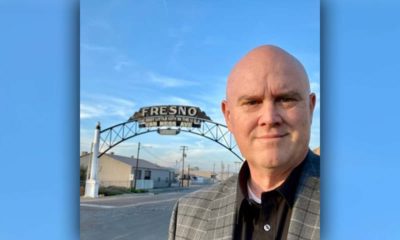 Image of Bob Nelson in front of the "Fresno" sign downtownRes