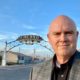 Image of Bob Nelson in front of the "Fresno" sign downtownRes