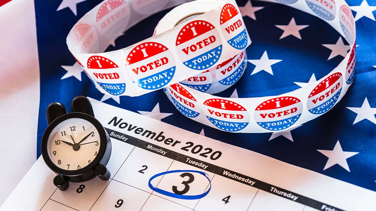 Image of calendar, an alarm clock, and I voted stickers for the November 2020 election