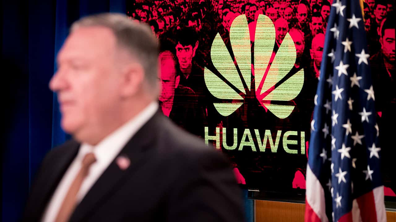 Photo of the Huawei logo and Mike Pompeo