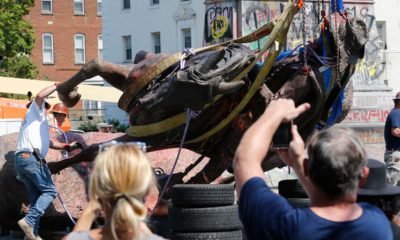 Photo of crews lowering a statue