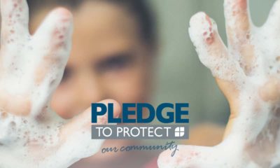 Image of a man with soap-covered hands pledging to stop the spread of COVID-19