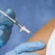 Photo of a flu shot vaccination going into a patient's arm